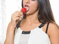 Passionate housewife Karen licks a strawberry before unclothing for muff play