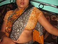 Mature Indian housewife tucks out her tongue while uncovering her all-natural baps