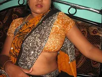 Mature Indian housewife tucks out her tongue while uncovering her all-natural baps