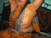 Mature Indian housewife tucks out her tongue while uncovering her all-natural baps