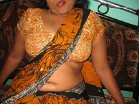 Mature Indian housewife tucks out her tongue while uncovering her all-natural baps