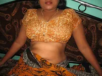 Mature Indian housewife tucks out her tongue while uncovering her all-natural baps
