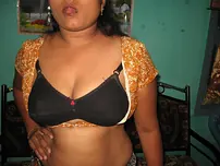 Mature Indian housewife tucks out her tongue while uncovering her all-natural baps