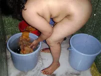 Indian fatty washes her clothes while taking a bathroom at the same time