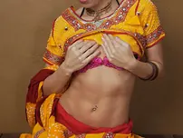 Indian fledgling works free of traditional clothing for a nude shoot