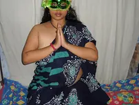 Big Indian doll Delicious decorates up her bare milk cans after getting nude in a mask