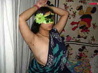 Big Indian doll Delicious decorates up her bare milk cans after getting nude in a mask