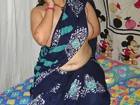 Big Indian doll Delicious decorates up her bare milk cans after getting nude in a mask