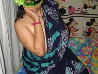Big Indian doll Delicious decorates up her bare milk cans after getting nude in a mask