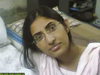 Indian lady takes selfies in a mirror while wearing a watch-thru tank top