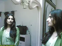 Indian lady takes selfies in a mirror while wearing a watch-thru tank top