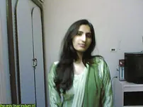 Indian lady takes selfies in a mirror while wearing a watch-thru tank top