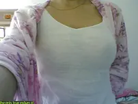 Indian lady takes selfies in a mirror while wearing a watch-thru tank top