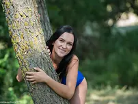 Dark-haired nubile Indiana Blanc liquidates a bikini to stance naked in a brook