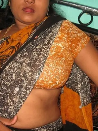 Mature Indian housewife tucks out her tongue while uncovering her all-natural baps