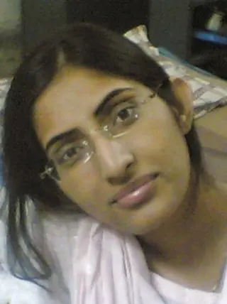 Indian lady takes selfies in a mirror while wearing a watch-thru tank top