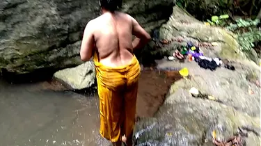 Ashok and Surwana Kumari take turns pissing in public while bathing in a pond in the woods
